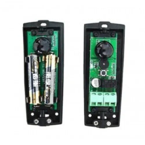 Two open infrared photocell sensors showing batteries, circuit boards, optical components, and wiring terminals for gates.