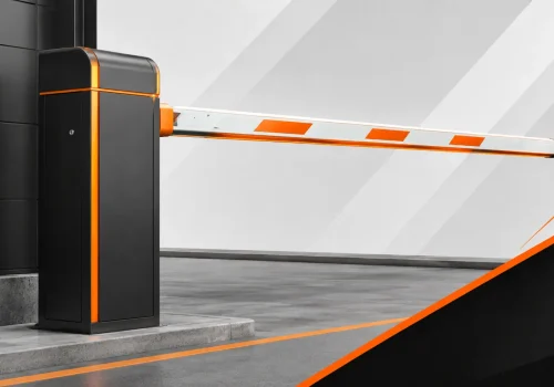 Automatic parking barrier gate with orange accents controlling vehicle access at a modern entry point.